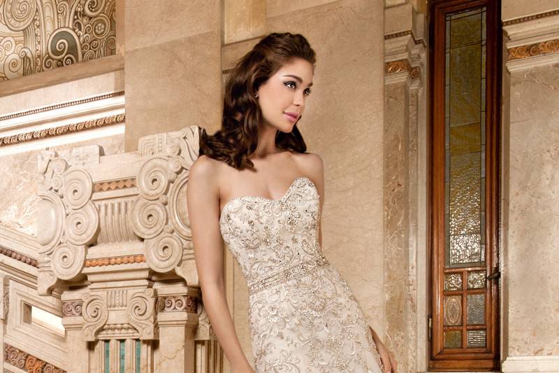 4326This exquisite, sleeveless, elaborately beaded form fitting gown features a sheer neckline and low sheer back with magnificent beaded embroidery. The back is finished with a semi-chapel train.