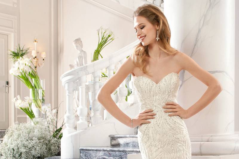 208This sophisticated fit n flare gown with sweetheart neckline is embellished with magnificent beaded embroidery and a multi feathered skirt and train. The sheer beaded back features a button closure.