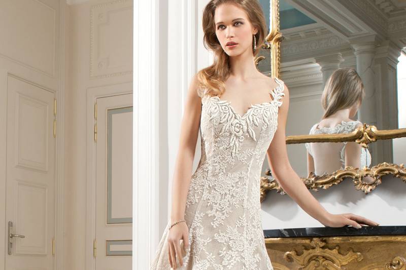 219This all lace a-line gown features a unique design of flower embroidery on the v-neckline and straps transitioning into a dramatic, low keyhole back. Delicate venise lace embellishes entire gown and chapel train.