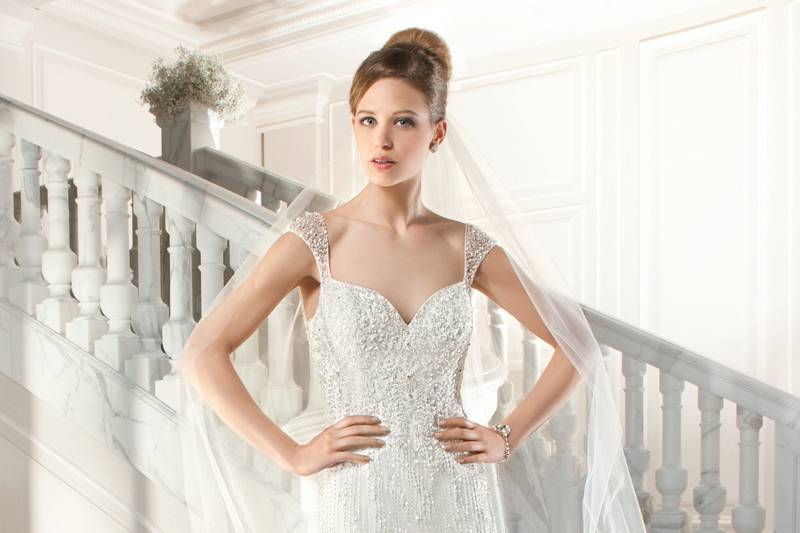 219This all lace a-line gown features a unique design of flower embroidery on the v-neckline and straps transitioning into a dramatic, low keyhole back. Delicate venise lace embellishes entire gown and chapel train.