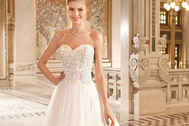 260This flowing soft tulle strapless ball gown features a sweetheart neckline and delicate beaded lace on the bodice. The back features a lace-up closure and chapel length train.