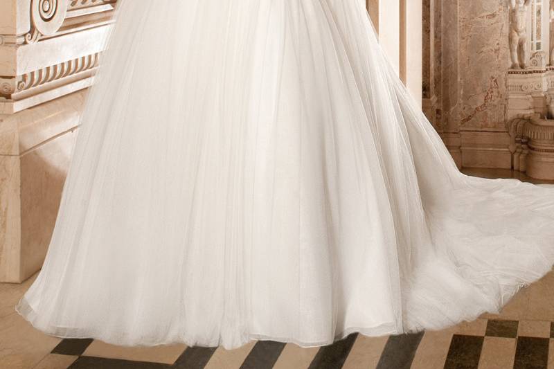 262This elegant soft tulle strapless ball gown features beaded embroidery on the bodice and attached beaded belt with crystal accents on the waist. The tulle skirt flows into a chapel length train.