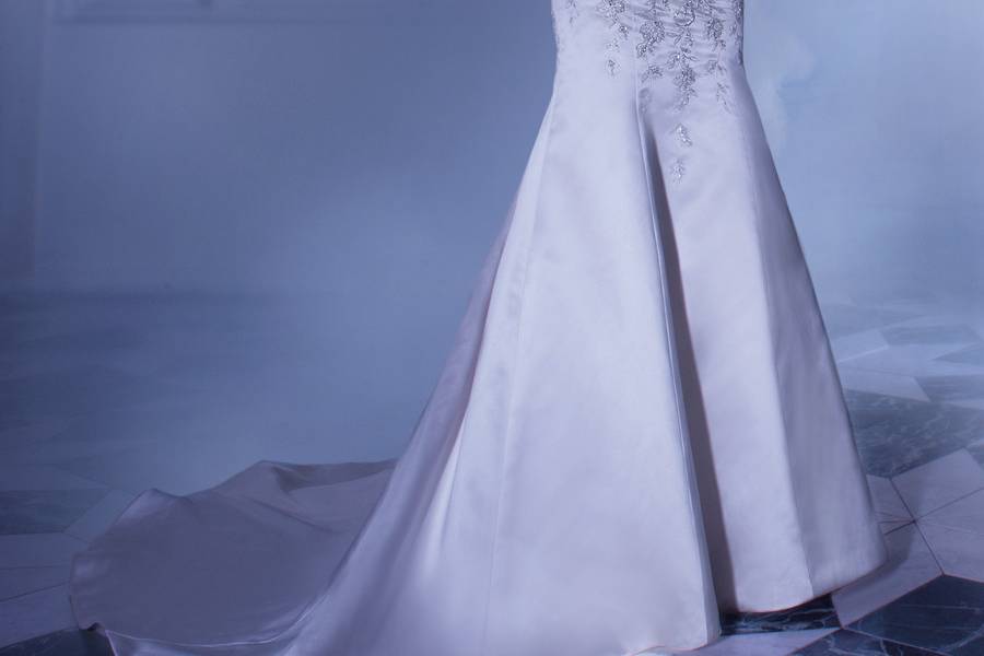 4315Satin, A-line wedding gown with a beaded lace bodice featuring a Sweetheart neckline cap sleeves and high lace keyhole back. This bridal dress also features a pleated wrap waist and split bustled skirt with tulle and lace underlay. Back is finished with buttons and attached bustled skirt.