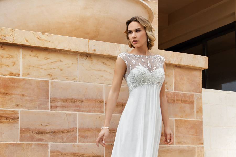 186 Chiffon, Strapless destination wedding gown with a Soft Sweetheart neckline and Empire ruched bodice embellished with beaded motif. The A-line skirt on this bridal dress features a Chapel train.