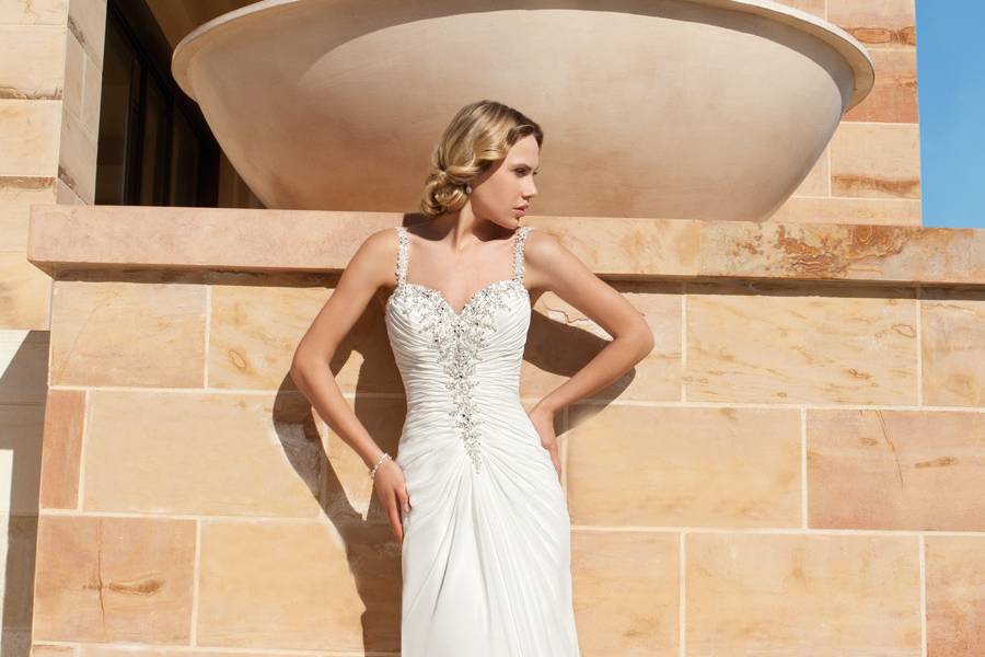 190Chiffon, A-line destination wedding gown with a Sweetheart neckline, beaded straps and ruched bodice embellished with beading. The low back on this bridal dress features buttons and Sweep train.