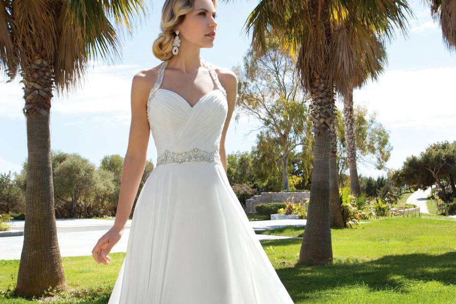 199 Chiffon, A-line halter destination wedding gown with a Sweetheart neckline and ruched bodice. Waist and halter straps are embellished with jeweled beading. The skirt on this bridal dress features a Chapel train.