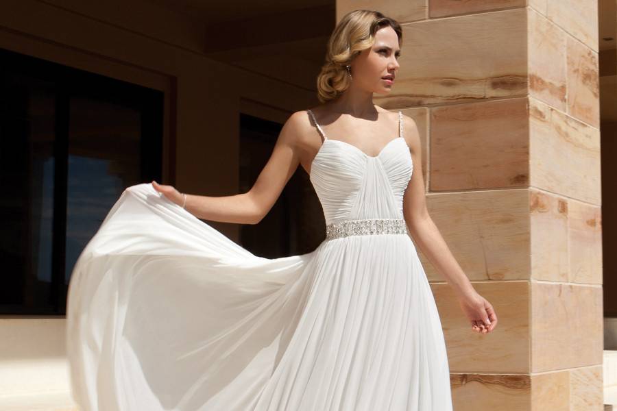 204Chiffon, One-shoulder, fit n flare destination wedding gown with a Sweetheart neckline, asymmetrical ruching and beaded appliqué on bodice. This bridal dress features a Chapel length train.