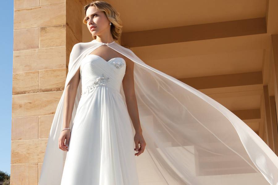 206Chiffon, A-line destination wedding gown with a V-neckline and ruched bodice with beaded embellishment on waist. The skirt on this bridal dress features a Chapel length train