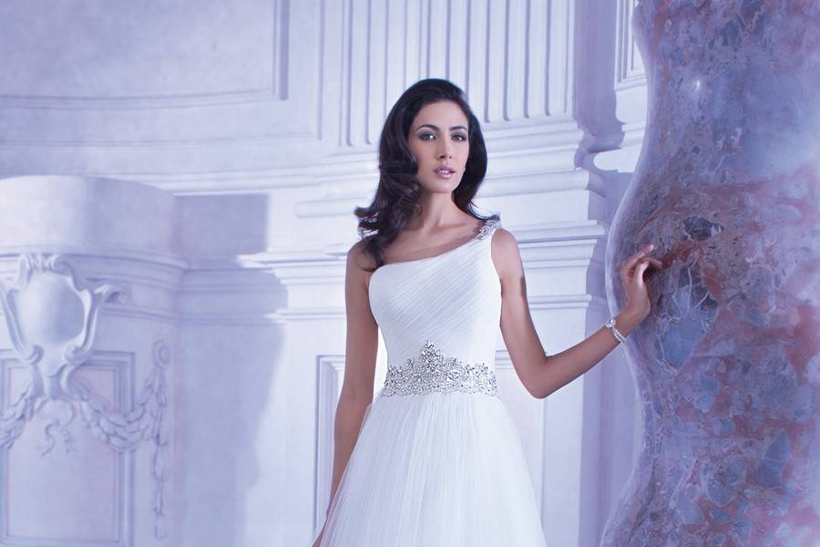 248Soft Tulle, One-shoulder A-line wedding gown with attached jewel-encrusted belt. This bridal dress has a Chapel train.