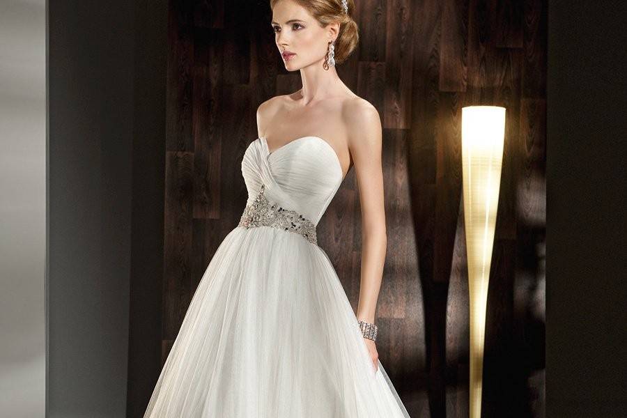 532 Soft tulle, A-line wedding dress has a strapless, sweetheart neckline. The ruched bodice and beaded jewel encrusted belt complete this bridal gown's look.