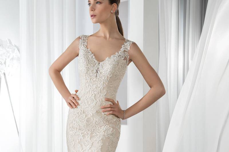 Style 585 <br> This all lace Fit-N-Flare gown features a V-neckline, lace straps that transition into a low open back and lace over tulle Chapel train.
