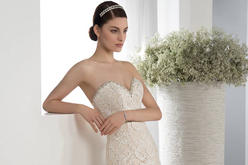 Style 587 <br> This elegant strapless, lace embellished, form fitting gown features a Sweetheart neckline with jeweled trim, lace-up back and Chapel length train.