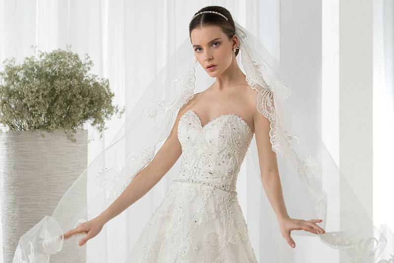 Style 614 <br> This romantic, strapless Tulle A-line gown with Sweetheart neckline is embellished with beaded lace and delicate crystal trim on waist.  The back is finished with a button closure and Chapel train.