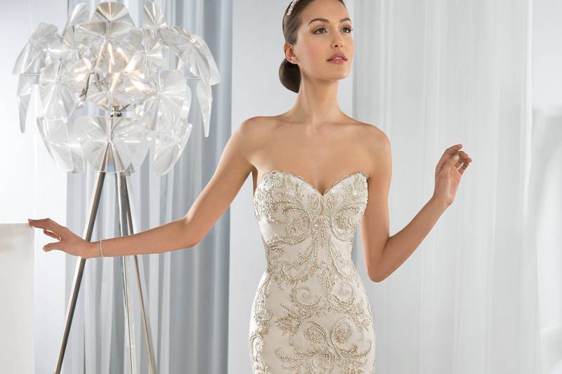 Style 619 <br> This Chic Beaded Lace Fit-N-Flare gown with a Sweetheart neckline outlined by lace scalloped edges, features a lace- up closure and a Chapel train.