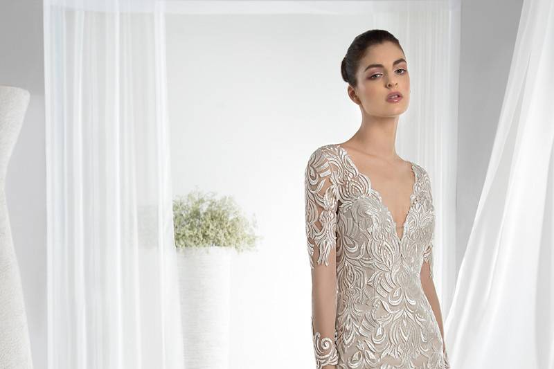 Style 622 <br> This elegant Fit-N-Flare lace gown features a plunging V-neckline long sheer sleeves transitioning into a dramatic key-hole back and Chapel train.