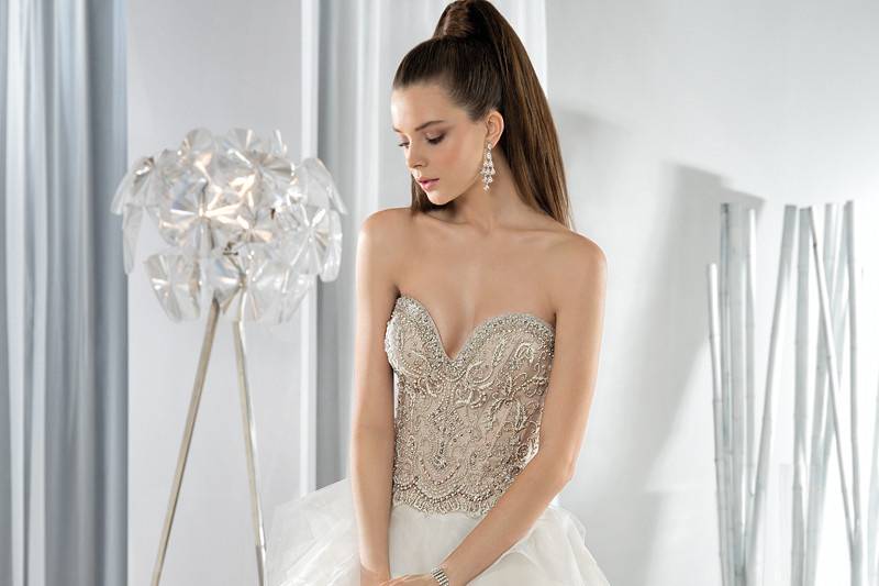 Style 623 <br> This magnificent organza ruffled Ball Gown features an intricately beaded bodice with a sweetheart neckline. The lace- up closure back cascades to a Chapel train.