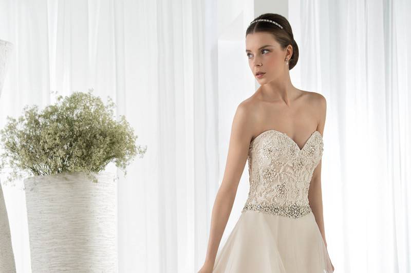Style 615 <br> This romantic strapless, Aline gown with Sweetheart neckline and jewel embellished belt on waist features beaded lace on the bodice and a magnificent flower lace embroidery throughout the Tulle skirt, hem and Chapel train.