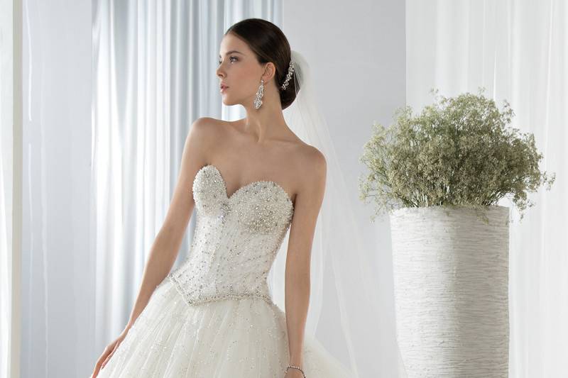 Style 649 <br> This magnificent beaded tulle Ball Gown is embellished with a sweetheart neckline beaded bodice and Basque waist. The back features lace- up closures and a Chapel length train.