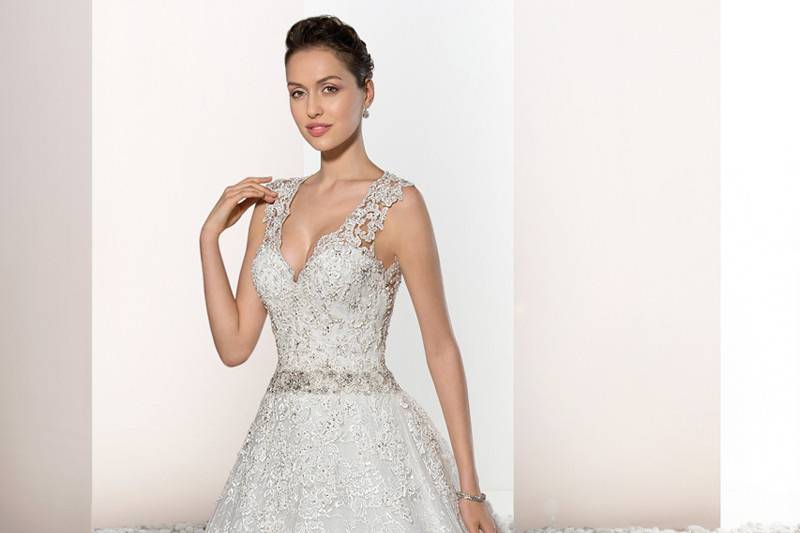 Style 731 <br>  This classic A-line gown with Sweetheart neckline features sheer lace cap sleeves that flow into a striking low illusion back with lace accents and lace embellished Cathedral train.