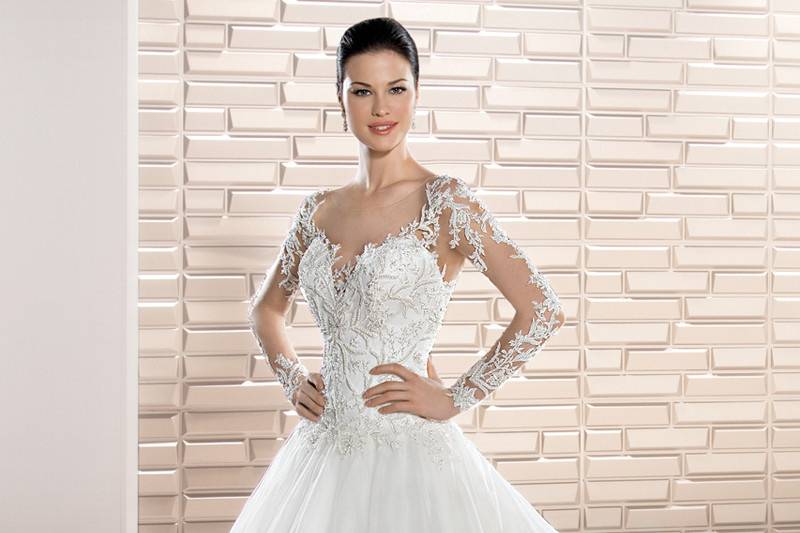 Style 730 <br>    Beautiful Chantilly and Alencon lace embellish this timeless V-neck Ball gown featuring a crystal encrusted belt and exquisite Sheer back with lace accents and a button closure.  A magnificent Cathedral train adds the finishing touch.