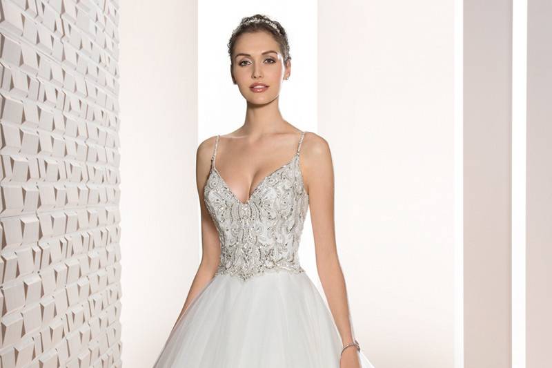 Style 723 <br>	Shimmering beaded embroidery and a luxurious Tulle skirt create this stunning Ball gown with V-Neckline, low V-back and Chapel length train.