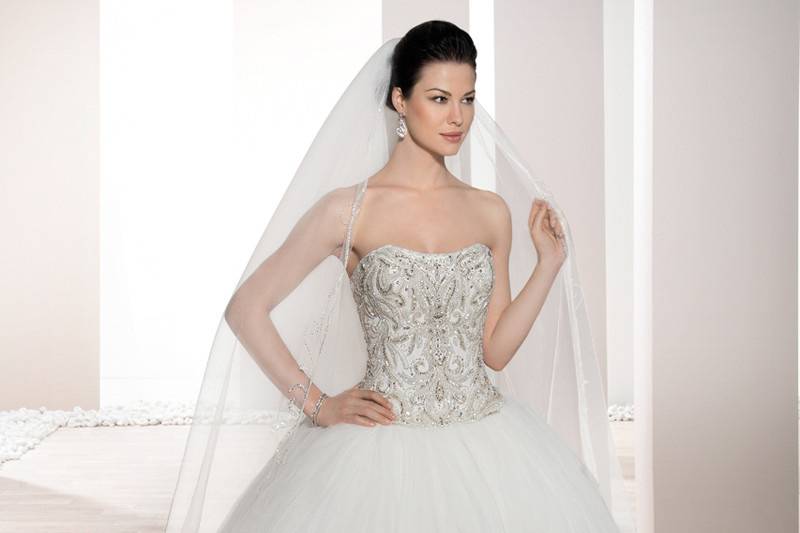 Style 722 <br>	This elegant Ball gown features a richly embellished beaded bodice with soft Sweetheart neckline and stunning Tulle skirt with Sweep train.