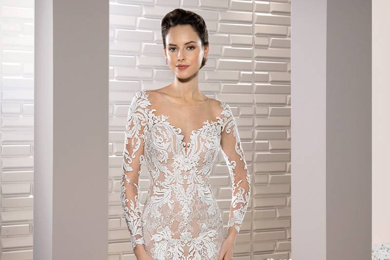 Style 717 <br>	Richly embroidered luxurious lace adorns this stunning fit n flare gown with Sweetheart neckline, long sleeves, Chapel train and dramatic low sheer back with buttons.