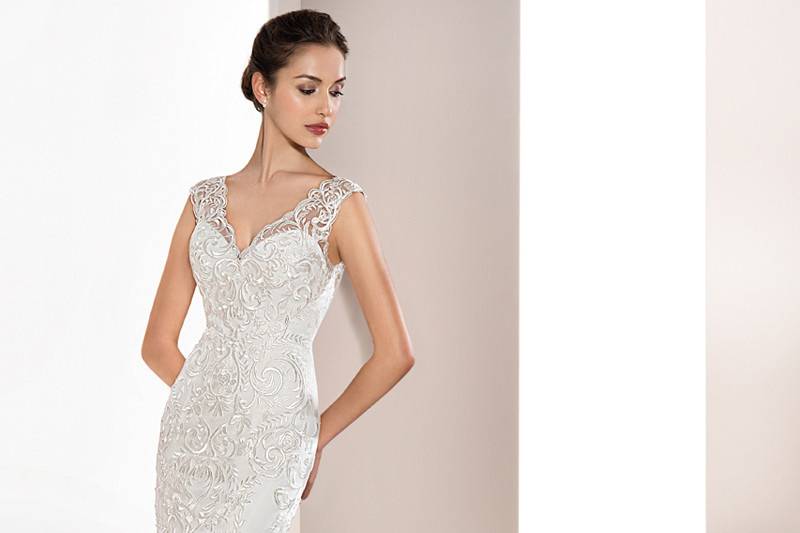 Style 714 <br>	This romantic lace over tulle sheath gown with Sweep train features a Sweetheart neckline and delicate lace embroidery on the shoulders flowing into a stunning sheer back adorned with lace embroidery and button closure.