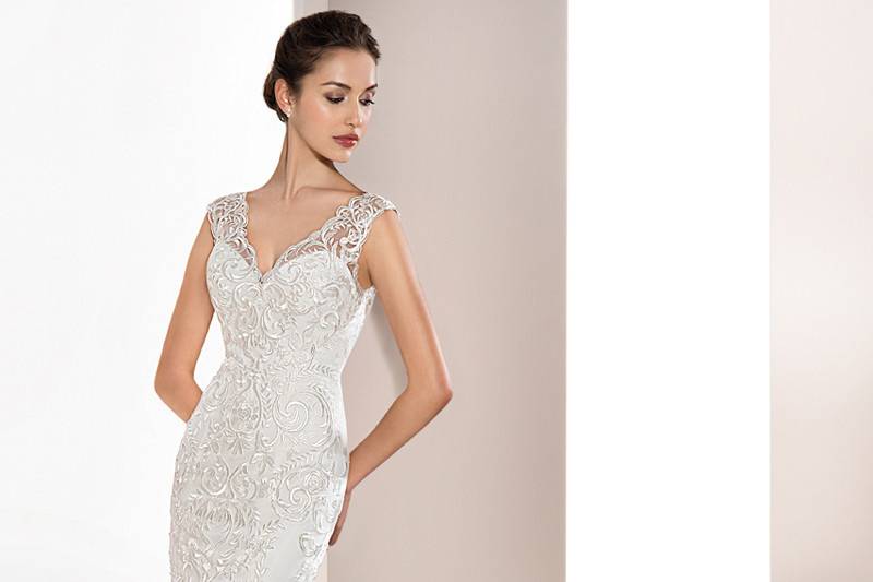 Style 715 <br>	This Chic strapless sheath gown features richly embroidered lace with Sweep train over a mini silhouette and delicately beaded belt on the waist.