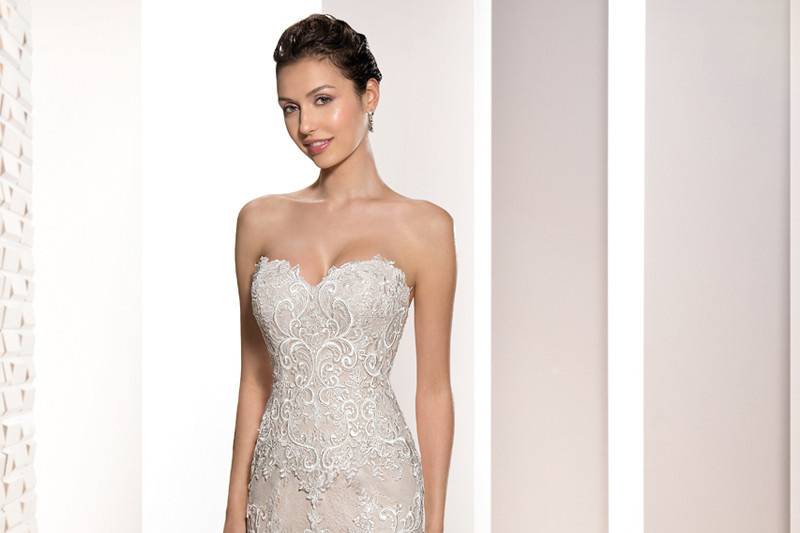 Style 710 <br>	This unique embroidered Venice lace fit n flare gown features a barely there sheer neckline over a Sweetheart silhouette and artfully embroidered lace over sheer illusion back.