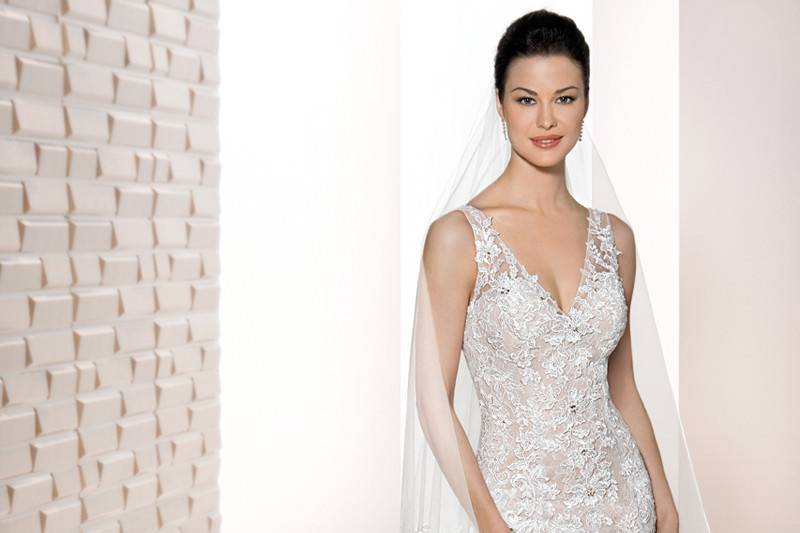 Style 709 <br>	Exquisite intricate lace embroidery embellishes this classic strapless Sheath silhouette featuring a  Chapel train and stunning shear lace back adding a touch of drama.