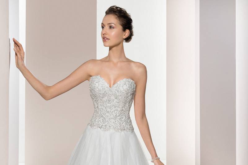 Style 687 <br>	This romantic Strapless gown with a beaded lace embellished bodice and soft tulle skirt features a Sweetheart neckline and Sweep train.