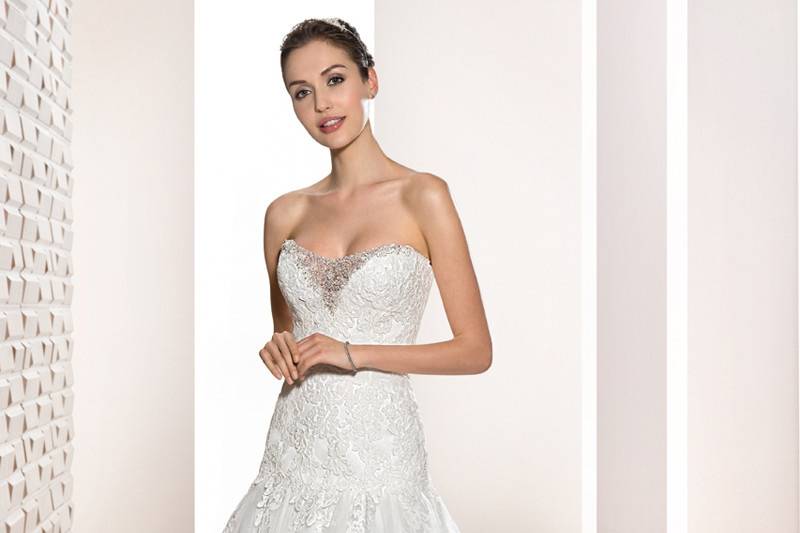 Style 685 <br>	Chic and Sophisticated,  this sheath gown with lace-up back features a Sweetheart neckline with removable cap sleeves and is adorned with beaded lace appliques that cascade into an ethereal Chapel train.