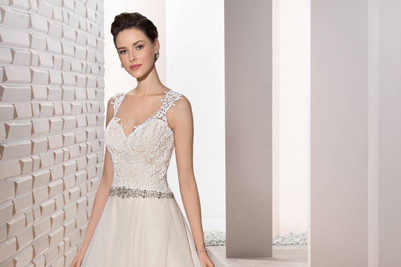 Style 700 <br>	This exquisite Crepe Halter Sheath features a stunning bead embellished high neckline that flows into a magnificent jeweled motif over sheer illusion and draped Sweep train.