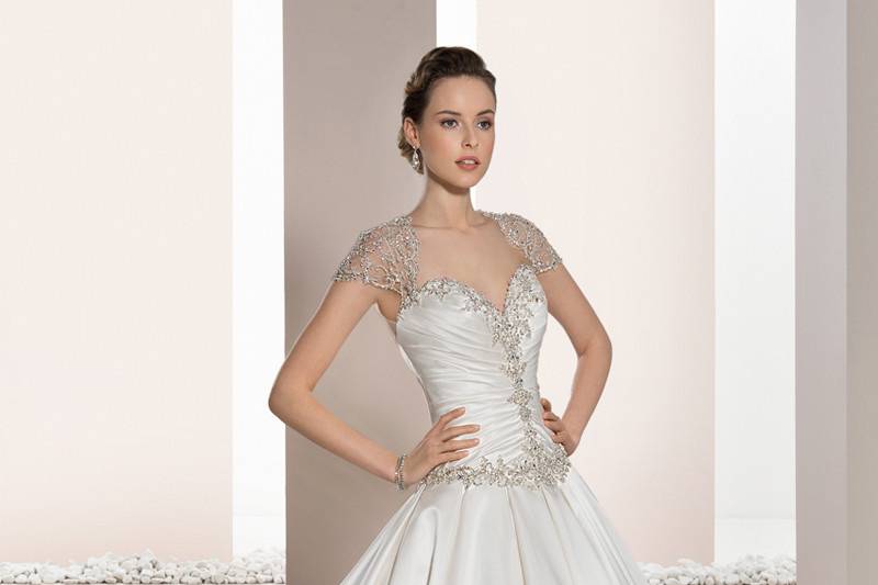 Style 671 <br>	This exquisite, strapless, A-line gown with soft Sweetheart neckline is embellished with magnificent beaded embroidery over tulle.  The back features a lace-up closure and beaded embroidery. cascading into the Chapel train.