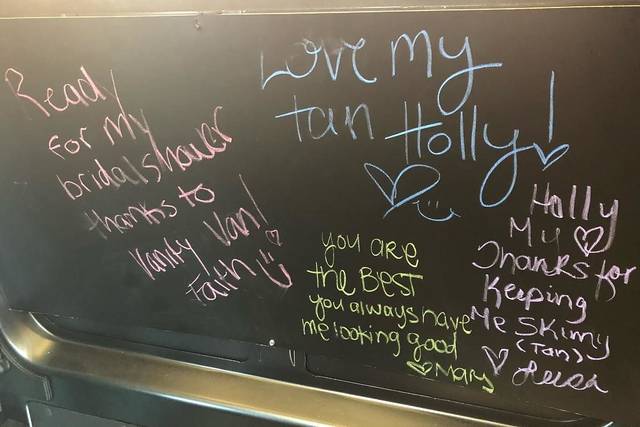 Chalk board wall inside the mobile salon. Our clients love us. Lots of brides