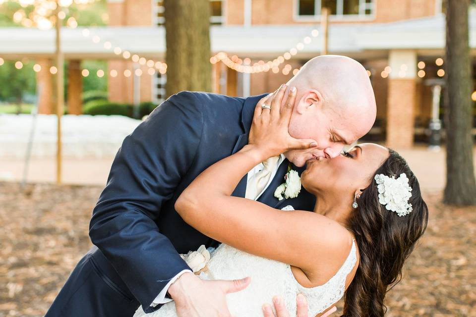 Newlyweds dip for a kiss