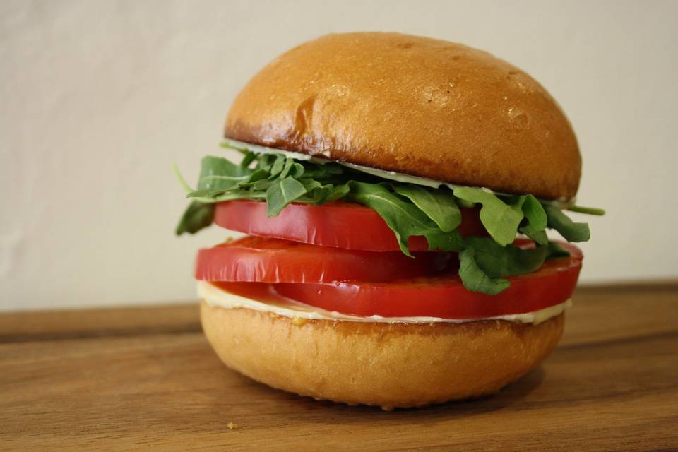 Heirloom Tomato Sandwich w/ house garlic aioli, freshly sliced heirlooms, and crisp arugula. (seasonal)