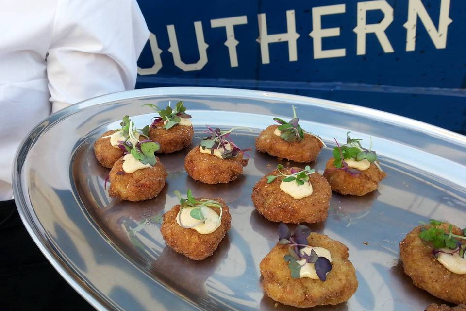 Crab Cakes w/ a house remoulade sauce and micro greens.