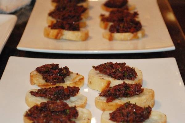 Layered bruschetta is wonderful with fresh, homemade ricotta cheese, tapenade and sundried tomatoes.