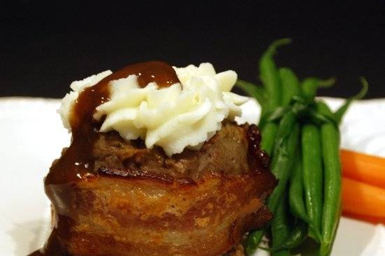 Crispy bacon-wrapped meatloaf bundts with creamy smashed potatoes.