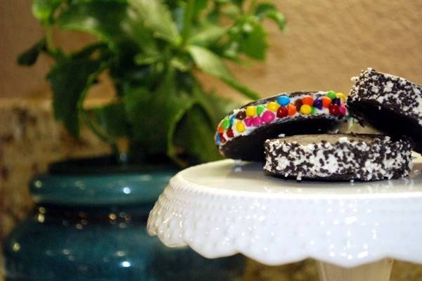 Fun and colorful homemade sandwich cookies with light cream filling and dusted with sweetness.