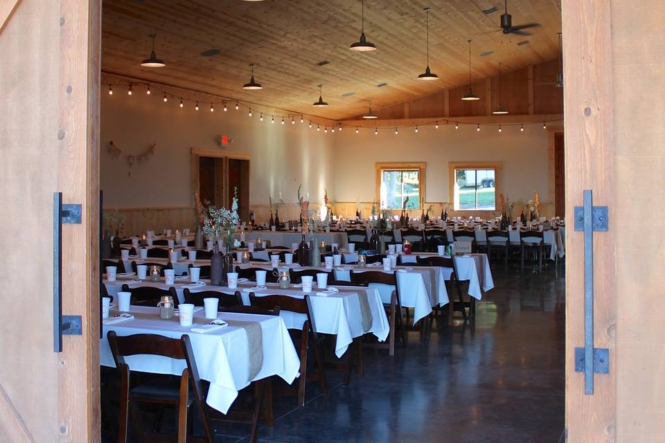 Open the authentic equestrian barn doors to enter the Blue Sage Barn reception