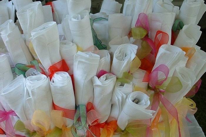 White Hemstitch Napkins tied with colorful ribbon