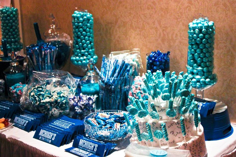 Beth & Brian were awesome clients – they made the job easy because they were always thinking about their guests and how they could make the night an enjoyable experience for the family and friends they invited to share their day with them.
When it came time to plan out the details of the candy buffet, Beth gave us specific directions: there had to be gummy sharks (Brian seems to have a great interest in sharks), Skittles (Brian’s favorite candy) and we were directed to make sure there was a balance between chocolate sweets and fruity sweets. Oh, and you probably guessed, but we were also told to stick with the color blue