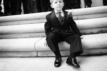 Ring bearer sitting on the steps of Mission Delores.