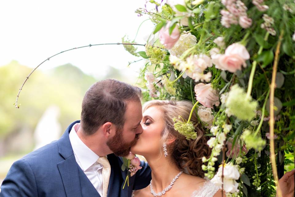 Just married kiss in flowers