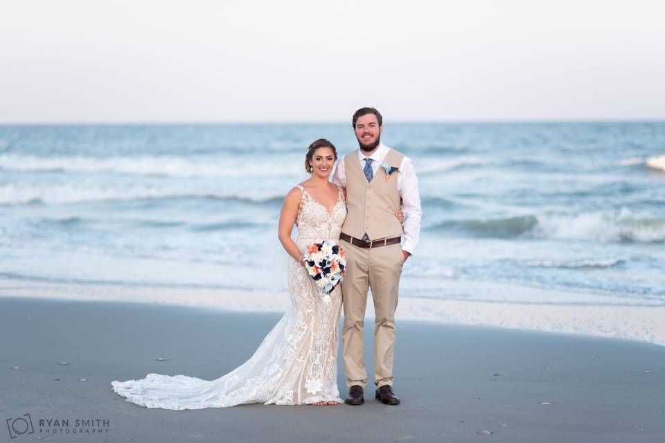 Bride and groom by ocean