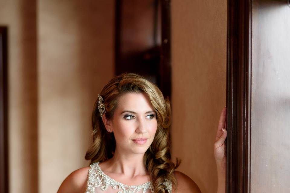 Bride standing in window light