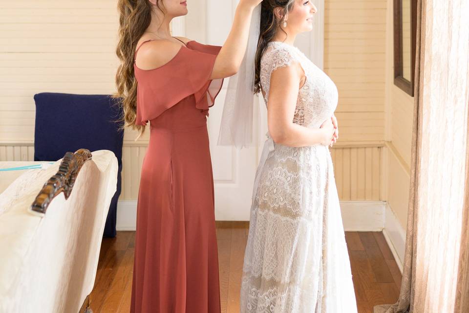 Daughter putting on mom's veil